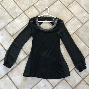 Black long sleeve, open back shirt.